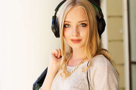 Young happy teenager is wearing headphonesの写真素材