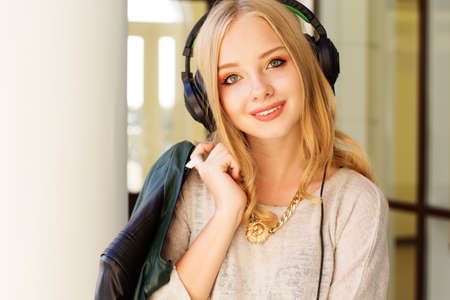 Young happy teenager is wearing headphonesの写真素材