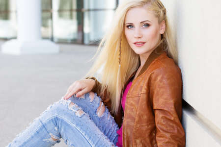 Nice blonde girl is wearing autumn clothesの写真素材