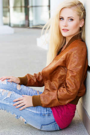 Nice blonde girl is wearing autumn clothesの写真素材