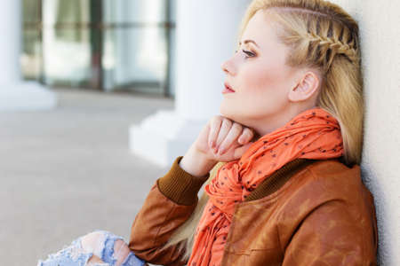 Nice blonde girl is wearing autumn clothesの写真素材