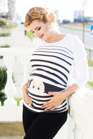 Pregnant girl is walking in park