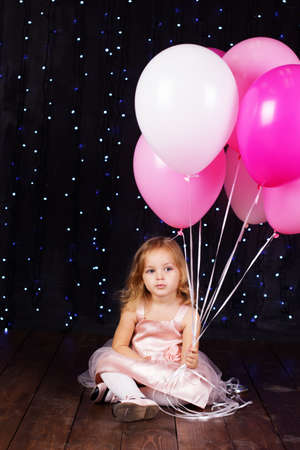 Little girl with pink balloonsの写真素材