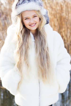 Cute little girl in winter clothes outdoorsの写真素材