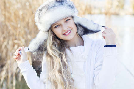Cute little girl in winter clothes outdoorsの写真素材