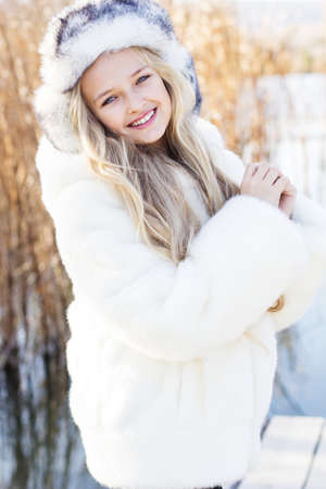 Cute little girl in winter clothes outdoorsの写真素材