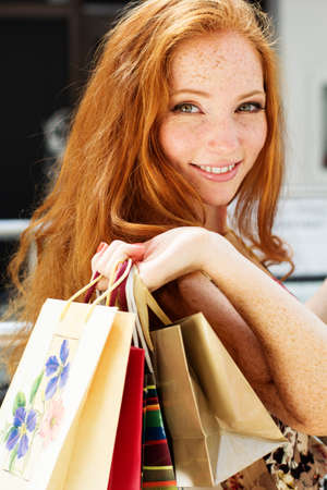 Attractive happy girl out shoppingの写真素材
