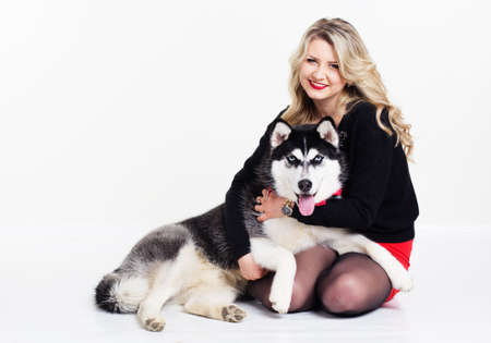 Young girl with her husky dog isolated on whiteの写真素材