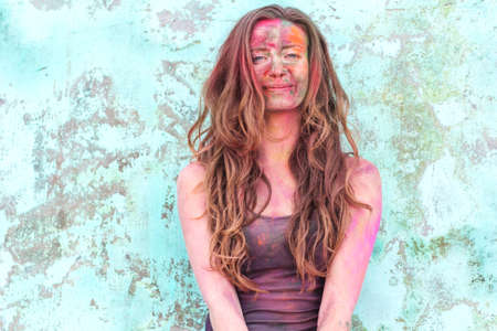 Portrait of an emotional girl with paint on her face, India, Holi festival, Rishikesh