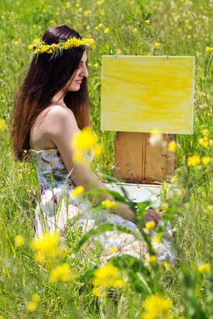 Young female artist painting an floral landscape, summer timeの写真素材