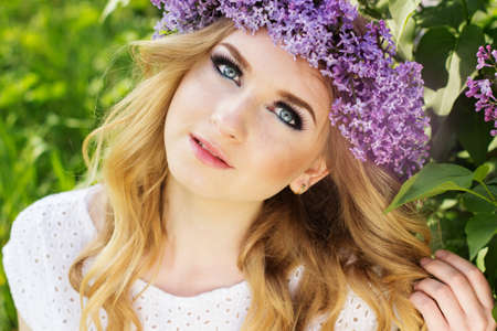 Portrait of beautiful teenager girl with wreath from lilac flowersの写真素材