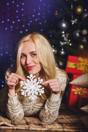 Happy smiling Santa girl with white snowflake are celebrating Xmas and Happy New year at home.の写真素材