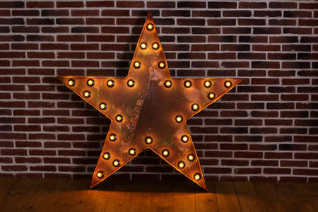 Lighting five-pointed star with lamps, decoration in studioの写真素材
