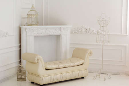 Light interior of room with white sofa and vintage metal hanger with wire dress formの写真素材