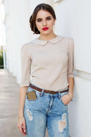 Beautiful business lady with phone in her pocketの写真素材