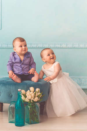 Couple of babies boy and girl are wearing fashion clothes in studioの写真素材