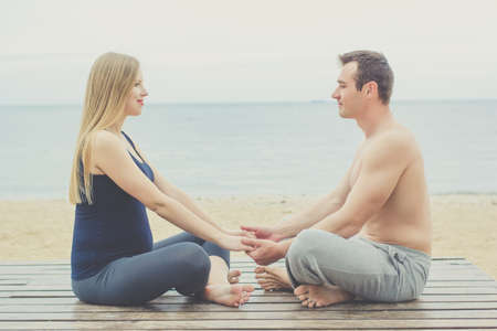 Young couple are doing gymnastic and yoga for pregnancyの写真素材