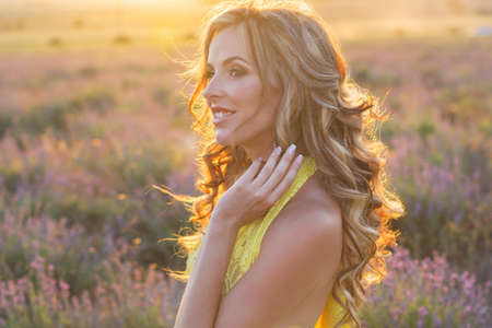 Portrait of fashion pregnant beautiful girl in a lavender fieldの写真素材