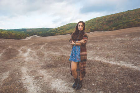 Portrait of young pretty woman is wearing clothes in bohemian style on the nature