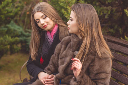 Two friends girl are wearing warm winter coatsの写真素材