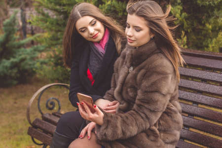 Two teen girls are taking selfie with smartphoneの写真素材