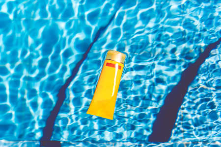Sunscreen lotion in swimming poolの写真素材