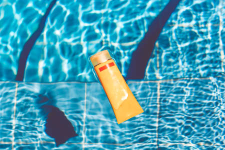 Sunscreen lotion in swimming poolの写真素材