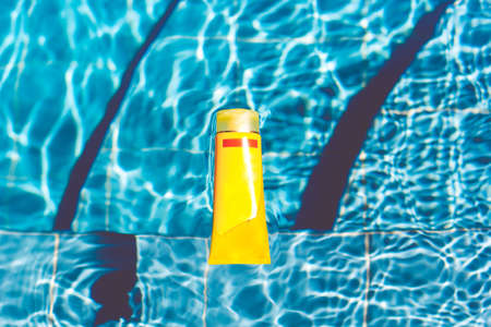 Sunscreen lotion in swimming poolの写真素材