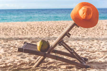Deck chair on the beach with coconutの写真素材