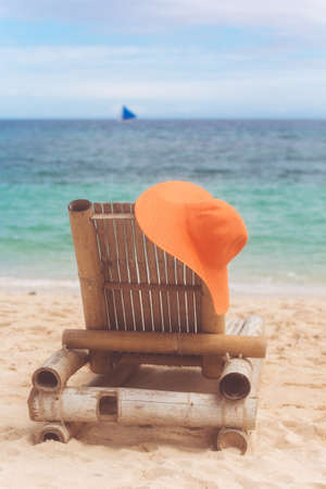Deck chair on the beach with hatの写真素材