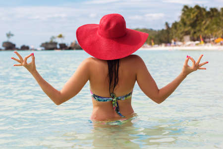 Fashion woman in tropical paradise doing meditationの写真素材