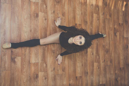 Sportive woman doing stretching exercise splitの写真素材
