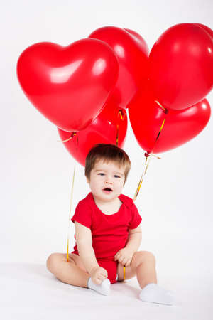 Little baby boy with red balloons  Valentines dayの写真素材