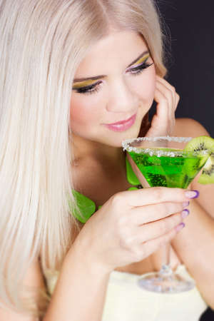 Sexy blonde gorl with green cocktailの写真素材