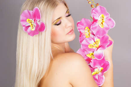 Portrait of very beautiful woman with orchidの写真素材
