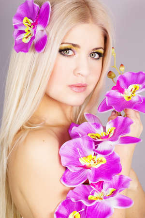 Portrait of very beautiful woman with orchidの写真素材