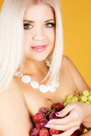 Beautiful blonde with grapesの写真素材