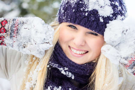 beautiful woman in warm clothing with snowの写真素材