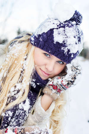 beautiful woman in warm clothing with snowの写真素材