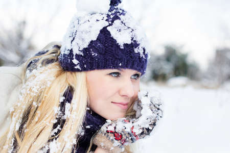 beautiful woman in warm clothing with snowの写真素材