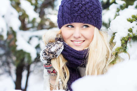 beautiful woman in warm clothing with snowの写真素材