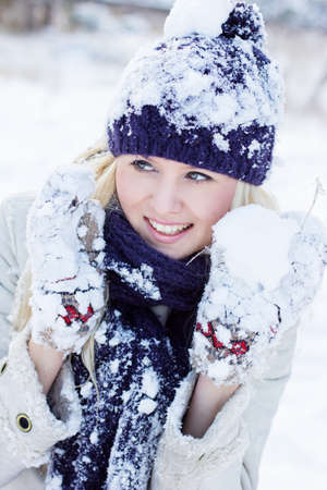 beautiful woman in warm clothing with snowの写真素材