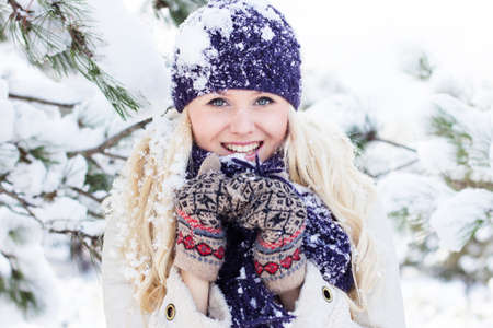 beautiful winter woman playing with snow