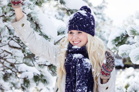 beautiful winter woman playing with snowの写真素材