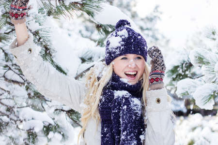 beautiful winter woman playing with snowの写真素材