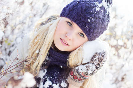 beautiful winter woman playing with snowの写真素材
