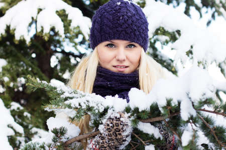 beautiful winter woman playing with snowの写真素材