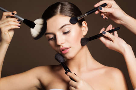 Visagist apply makeup for naturally beautiful womanの写真素材