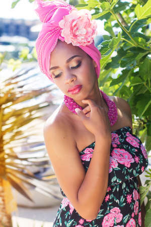 Portrait of young south african zulu woman with fashion makeup is wearing pink turban fashion dress and beadの写真素材