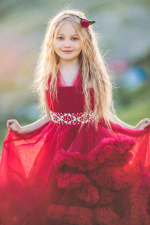 Child girl is wearing fashion dress on the hillの写真素材